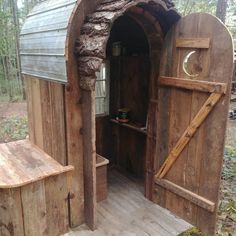 an outhouse made from wooden boards and logs