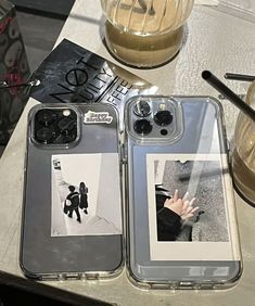 two cell phones sitting next to each other on a table