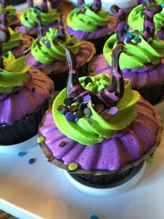 cupcakes decorated with green and purple frosting