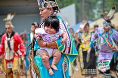 a woman holding a baby in her arms