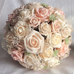 a bridal bouquet with pink and white flowers on a lace covered tablecloth background