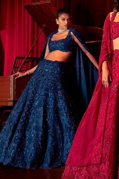 Navy blue organza based lehenga with attached cancan and all over 3D floral embroidery. Comes with embroidered padded blouse and dupatta.
Component: 3
Pattern: Embroidery
Type Of Work: 3D Floral, 3D Art Deco
Neckline: Square
Sleeve Type: Sleeveless
Fabric: Lehenga and Dupatta: Organza, Blouse: Organza, Chanderi
Color: Blue
Other Details: 
Art deco detailing on dupatta
Note: The red and green outfits worn by the other models are not for sale
Occasion: Reception,Bride - Aza Fashions Blue Organza Party Wear Choli, Blue Organza Gown For Reception, Blue Organza Lehenga For Party, Blue Fitted Organza Lehenga, Blue Organza Party Set, Blue Cutdana Party Gown, Blue Lace Work Dupatta For Party, Party Blue Dupatta With Lace Work, Blue Party Dupatta With Lace Work