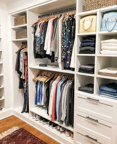 an organized closet with white shelving and drawers