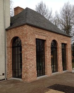 an old brick building with arched windows and doors