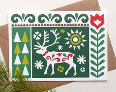 a christmas card with an image of a deer in the middle and trees around it