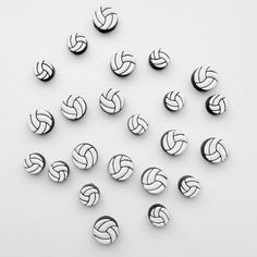 many silver colored volleyball balls on a white surface