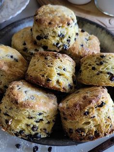 a plate full of biscuits with raisins on top