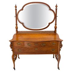 an antique wooden dresser with mirror on it's top and drawer underneath the mirror