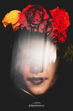 a woman's face with flowers on her head in front of the image is black