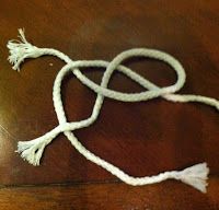 a white cord on top of a wooden table