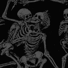 two skeletons sitting next to each other on a black and white background with one skeleton holding the other's hand