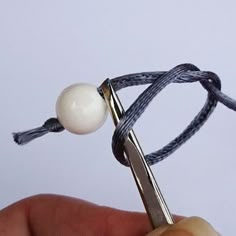 a pair of scissors being used to string a ball