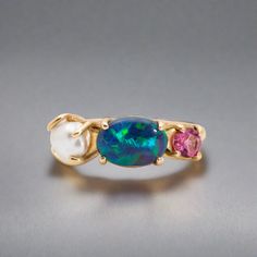 Introducing our exquisite Seascapes Collection, where nature's wonders come to life in the form of a stunning 14k gold ring set. This handcrafted masterpiece showcases the perfect harmony between the earth and the sea, capturing the essence of elegance and beauty. At the heart of this mesmerizing ring is a captivating 1ct Australian Opal, renowned for its vibrant play of colors that mirror the enchanting hues of the ocean. Complementing this ethereal gemstone are delicate pink tourmaline accents Australian Opal Ring, Australian Black Opal, Black Opal Ring, Lightning Ridge Opal, Claw Setting, Gold Ring Sets, Lightning Ridge, Keshi Pearls, Exclusive Jewelry