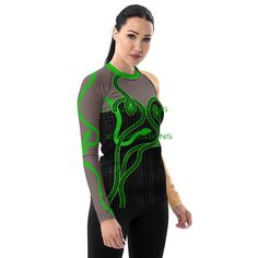 Taylor inspired reputation outfit with green snakes. This cute top is perfect for concerts, Halloween, or just for fun. (Does NOT have real glitter, sparkles, or sequins, designs is printed onto fabric.) Matching leggings are sold in the listing below.  https://www.etsy.com/listing/1760662215/taylor-inspired-reputation-leggings?click_key=21f727190fa1eacad4b83a2ec8eb5ff8d4b260af%3A1760662215&click_sum=26e7bc8a&ref=shop_home_active_2&frs=1&sts=1 Don't be afraid to be your most active self in this smooth and versatile long-sleeve rash guard! It protects you from the sun, wind, and other elements while doing sports, and the slim fit, flat ergonomic seams, and the longer body gives extra comfort. * 82% polyester, 18% spandex * 6.78 oz/yd² (230 g/m²) (weight may vary by 5%) * Very soft four-way Fitted Rave Tops For Halloween, Green High Stretch Party Tops, Fitted Green Top For Streetwear, Fitted Long Sleeve Rave Top, Fitted Graphic Print Rave Top, Concert Outfit Green, Snake Skin Design, Fabric Matching, Green Snake