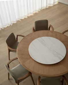 a wooden table with four chairs around it