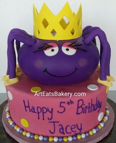 a birthday cake with a purple spider on top and a happy 5th birthday crown on top