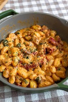 a pan filled with pasta and sauce on top of a table