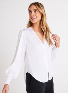 This stylish satin finish blouse is the perfect addition to your wardrobe. With its smocked cuff and button-down design, it offers a comfortable and trendy fit. Whether you're dressing up for a special occasion or keeping it casual, the Smocked Cuff Button Down is sure to make a statement. 100% Satin Ecovero. Chic Blouse With Smocked Cuffs For Brunch, Feminine Workwear Blouse With Smocked Cuffs, Balloon Sleeve Blouse With Smocked Cuffs For Brunch, Chic Workwear Blouse With Smocked Cuffs, White Blouse With Balloon Sleeves And Smocked Cuffs, Classic Blouse With Balloon Sleeves And Button Cuffs, Button-up Blouse With Smocked Cuffs For Work, Elegant Tops With Balloon Sleeves And Button Cuffs, Button-up Workwear Blouse With Smocked Cuffs