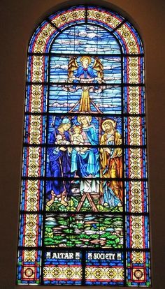 a large stained glass window inside of a church