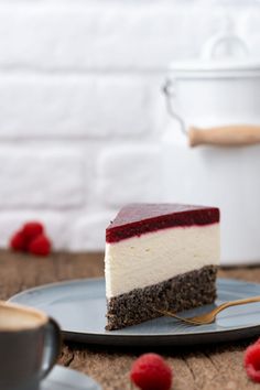 a piece of cheesecake on a plate with raspberries