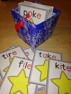 three cards with words that read fire and take kite on them next to a blue box