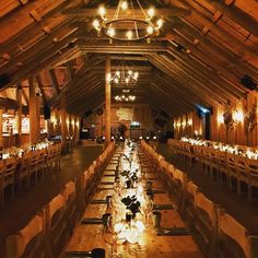 a long table is set up in an old barn