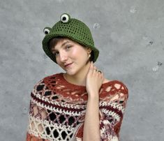 "Crochet frog bucket hat, Summer bucket hat, Animal hat More animal hats you can find here: https://etsy.me/3B4ySGh Green crochet hat with froggy eyes, perfect hat for frog lovers.  The hat is made of a soft yarn which is a blend of cotton and linen [55/45], perfect for spring and summer.  My hats are crocheted in the round, without any seams inside. Size: circumference: 55-58 cm [21.3\" - 23.5\"] Color: green. Because of different monitors and screen resolutions, colors may look different on the screen than in reality. If you want such a hat in any other color or size please feel free to contact me. I will be happy to make it for you.  Care instructions: Hand washes in lukewarm water (30o C), dry flat.  More hats you can find here: https://etsy.me/2KDvlcU Please take a look at my shop pol Cute Crochet Bucket Hat For Winter, Playful Crochet Bucket Hat, Playful Handmade Brimmed Bucket Hat, Handmade Playful Brimmed Bucket Hat, Handmade Playful Bucket Hat, Playful Handmade Bucket Hat, Cute Handmade Bucket Hat, Trendy Handmade Winter Bucket Hat, Handmade Fun Bucket Hat