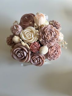 a bunch of flowers that are on top of a white surface, one is pink and the other is brown