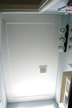 an overhead view of a bathroom with toilet paper on the wall and light coming in