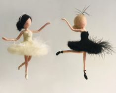 two dolls are flying in the air with their legs spread out and one is wearing a black dress