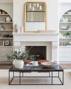 a living room filled with furniture and a large mirror on the wall over a fireplace