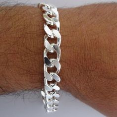 Solid .925 Sterling Silver 9 inch curb chain bracelet .925 Sterling Silver Italy curb chain in a 12mm width- Our most popular width. Not too heavy, good for everyday. We added a 19mm lobster clasp to the chain and it makes a very durable eye catching bracelet. 300 guage curb style chain bracelet- 9 inches (including lobster clasp) Stamped 925 Italy, for Authenticity. Finished with Lobster clasp, 38.8 grams 100% Genuine, 925 Sterling Silver Bracelet Arrives in a small gift Military Bracelet, Man Bracelet, Mens Chain, Diy Jewelry Rings, Mens Chain Bracelet, Crucifix Necklace, Link Chain Bracelet, Mens Silver Rings, Paracord Bracelets