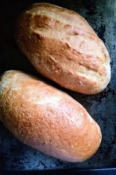 two loaves of bread sitting in a pan