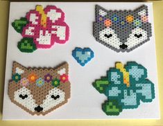 four cross stitch animal designs on a white board