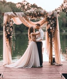 an instagram photo of a bride and groom kissing on the dock at their wedding