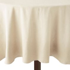 a white table cloth on top of a wooden stand