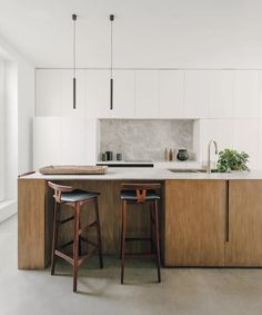 two stools are in front of the kitchen counter