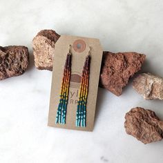 Embrace your inner bohemian goddess with our fan favorite long fringe beaded earrings. This unique rainbow color effect is inspired by a vibrant sunset over the ocean. Beautifully dramatic, comfortably lightweight. Enjoy the playful, free flowing style of beaded fringe earrings, without the weight. Featuring 4 strands of hand woven matte glass beads. These unique matte glass beads have a very luxe look and feel to them. Colors: These beaded earrings feature an ombre fade of semi-transparent purp Bohemian Rainbow Beaded Earrings With Fringe, Bohemian Rainbow Beaded Earrings For Summer, Bohemian Rainbow Beaded Earrings For Beach, Sunset Rainbow, Fringe Beaded Earrings, Sunset Over The Ocean, Beaded Fringe Earrings, Long Fringe, Long Fringes