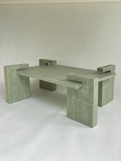 a concrete bench sitting on top of a white floor