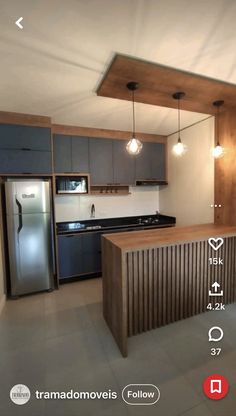 an empty kitchen with stainless steel appliances and wood accents on the countertop, along with wooden cabinetry