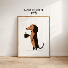 a framed poster with a dachshund holding a coffee cup in it's paws