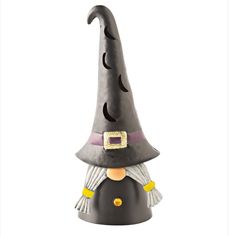 a small black witch's hat on top of a white table with yellow accents