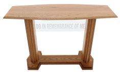 a wooden table with an acrylic sign underneath it that says do in remembrance of me