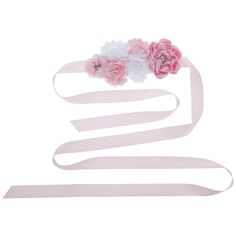 three pink and white flowers are on top of a ribbon that is being used as a decoration