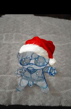 a small glass figurine wearing a santa hat