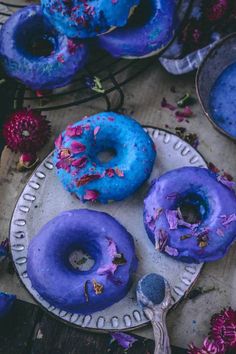 there are three donuts on the plate with blue glaze