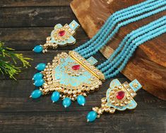 This is a stunning handmade necklace perfect for high end Jewelry Collector, a keeper in Traditional Vintage Indian/Pakistani Bridal jewelry and a Luxury Gift for your Daughter, Sister or Wife on Wedding or Anniversary. Perfect for any type of occasions, weddings And celebrations and a beautiful & memorable gift for weddings and special occasions. -Item Code:- L6062 -Sky Blue Gemstone Beaded Necklace Set with Earrings. -Designer multi layered faceted Sky Blue Gemstone beaded necklace. -Gold Plated Set with Kundan Stones which shine like Polki Diamonds. -Metal: Gold plated brass -Earrings are 70mm long & 36mm wide approx -Push Back Earrings -Necklace length with pendant 12" approx excluding adjustable dori/cord -Quantity:- One Necklace Set Please see more different designs here:- https://ww Pakistani Bridal Jewelry, Necklace Set With Earrings, High End Jewelry, Gemstone Beaded Necklace, Vintage Indian, Bridesmaid Necklace, Pakistani Bridal, Blue Gemstones, Brass Earrings