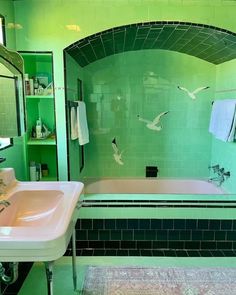 a bath room with a sink a tub and a mirror on the wall in it