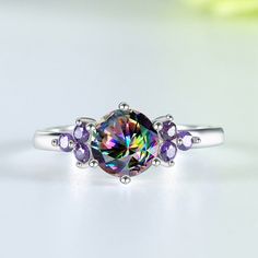 A ring as unique as you are! This sterling silver ring is set with a rainbow topaz and an amethyst, both of which have been faceted to catch the light. The result is a ring that's dazzling and eye-catching, perfect for any special occasion. Throughout history, mystic topaz has been associated with healing and good luck. As well as bringing good fortune, the stone is believed to have the power to ward off evil (or negative energy) while boosting your energy and positive feelings. Metals Type: 925 Positive Feelings, Rainbow Topaz, Amethyst Stones, Wedding Band Sets, Mystic Topaz, Gem Stone, Amethyst Stone, 925 Jewelry, Types Of Rings