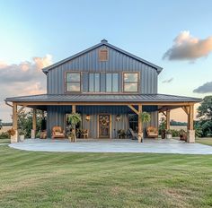 a large house sitting on top of a lush green field